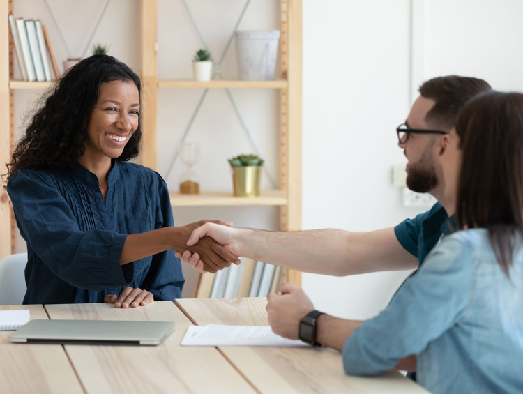 clients shaking hands with business woman