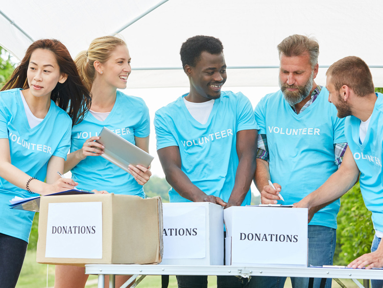 Group of volunteers with donation boxes